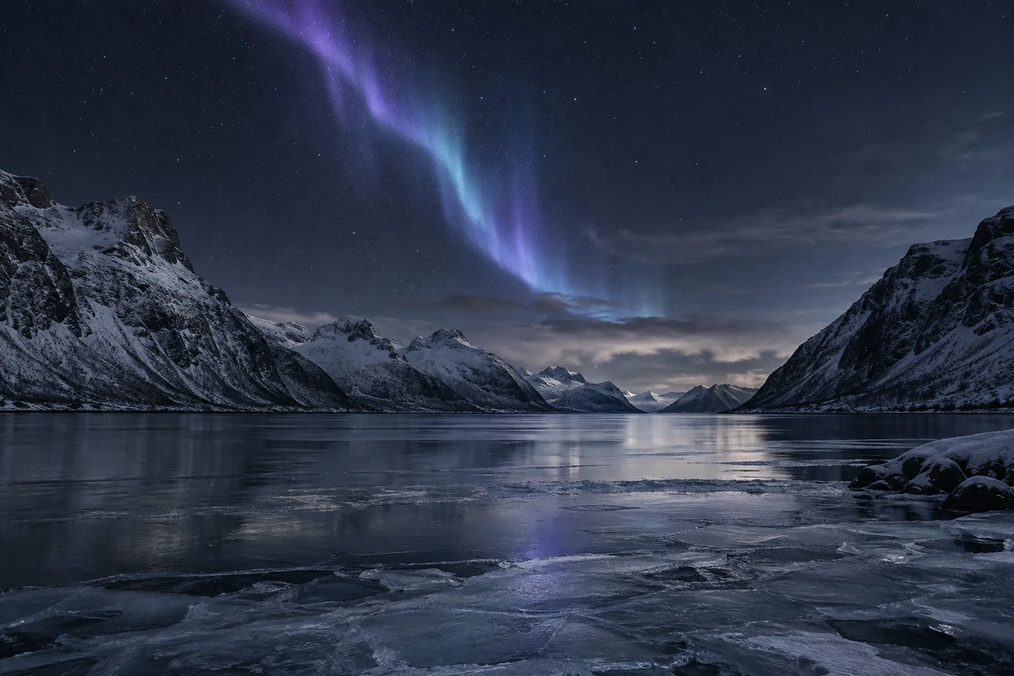 Northern lights above a frozen fjord.